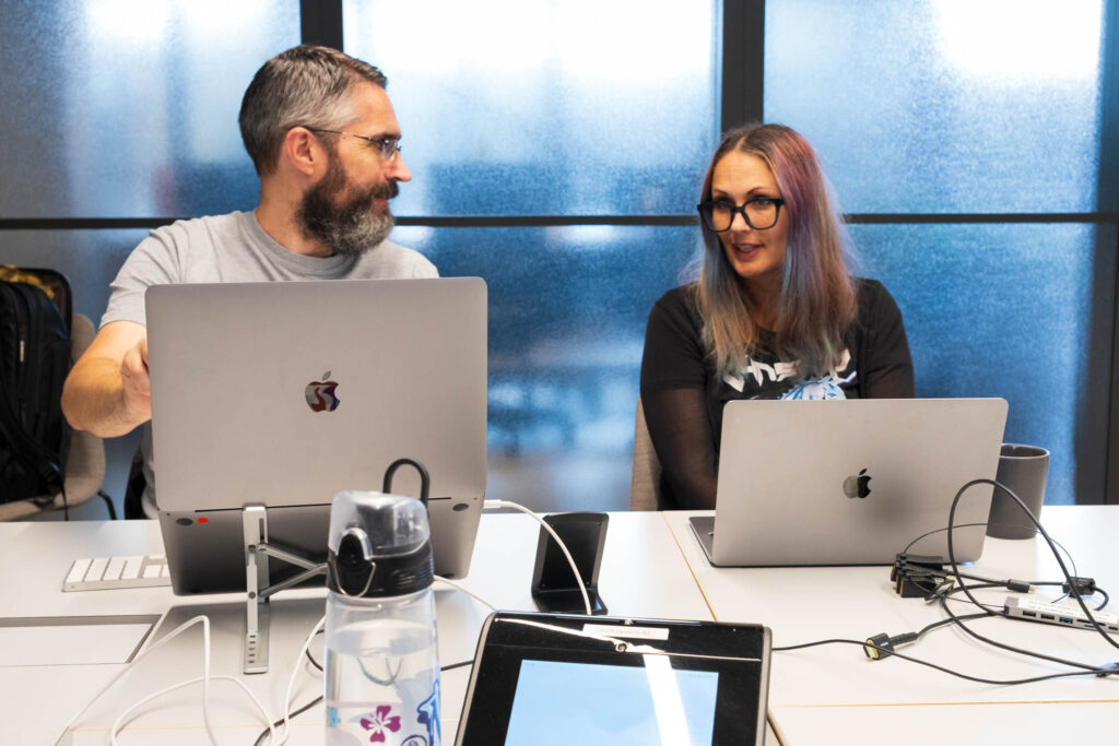 A picture showing two of the developers responsible for the Burges Salmon website, collaborating, discussing and creating strategy for more work to be done across the website