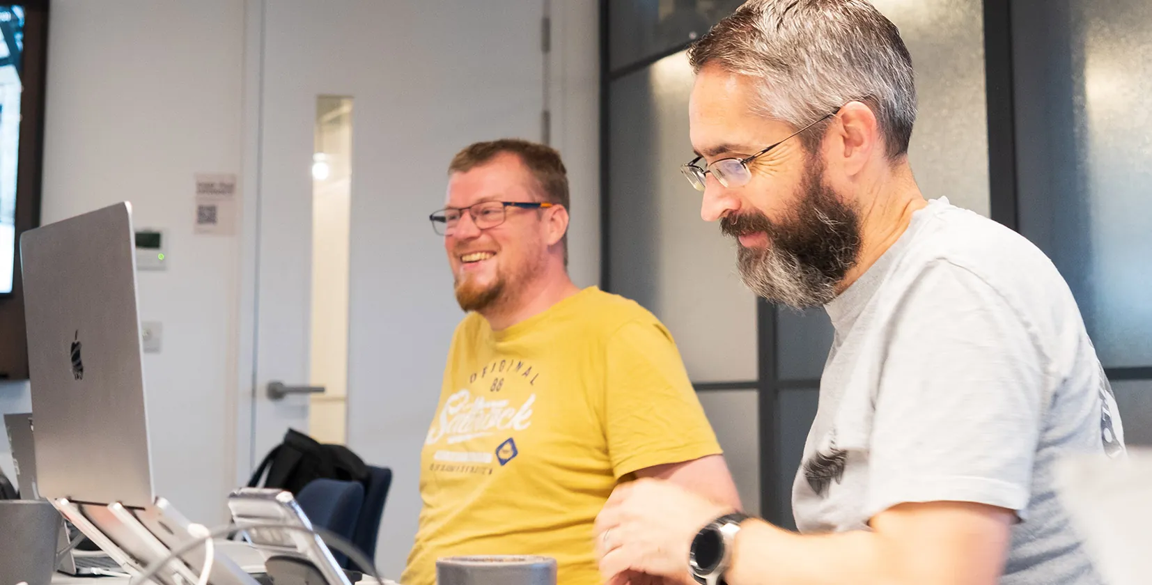 A picture of Ian Brown and Simon Pollard at the Illustrate Digital office in Bristol, two WordPress developers talking about website development