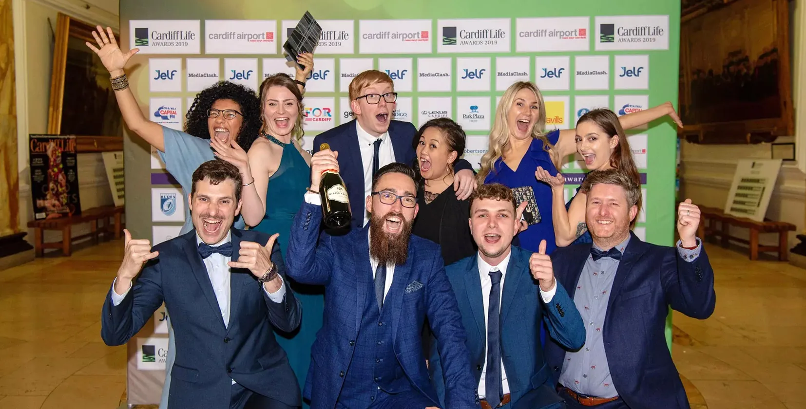 A picture of the Illustrate Digital team from 2019 winning the Cardiff Life Awards at City Hall in Cardiff