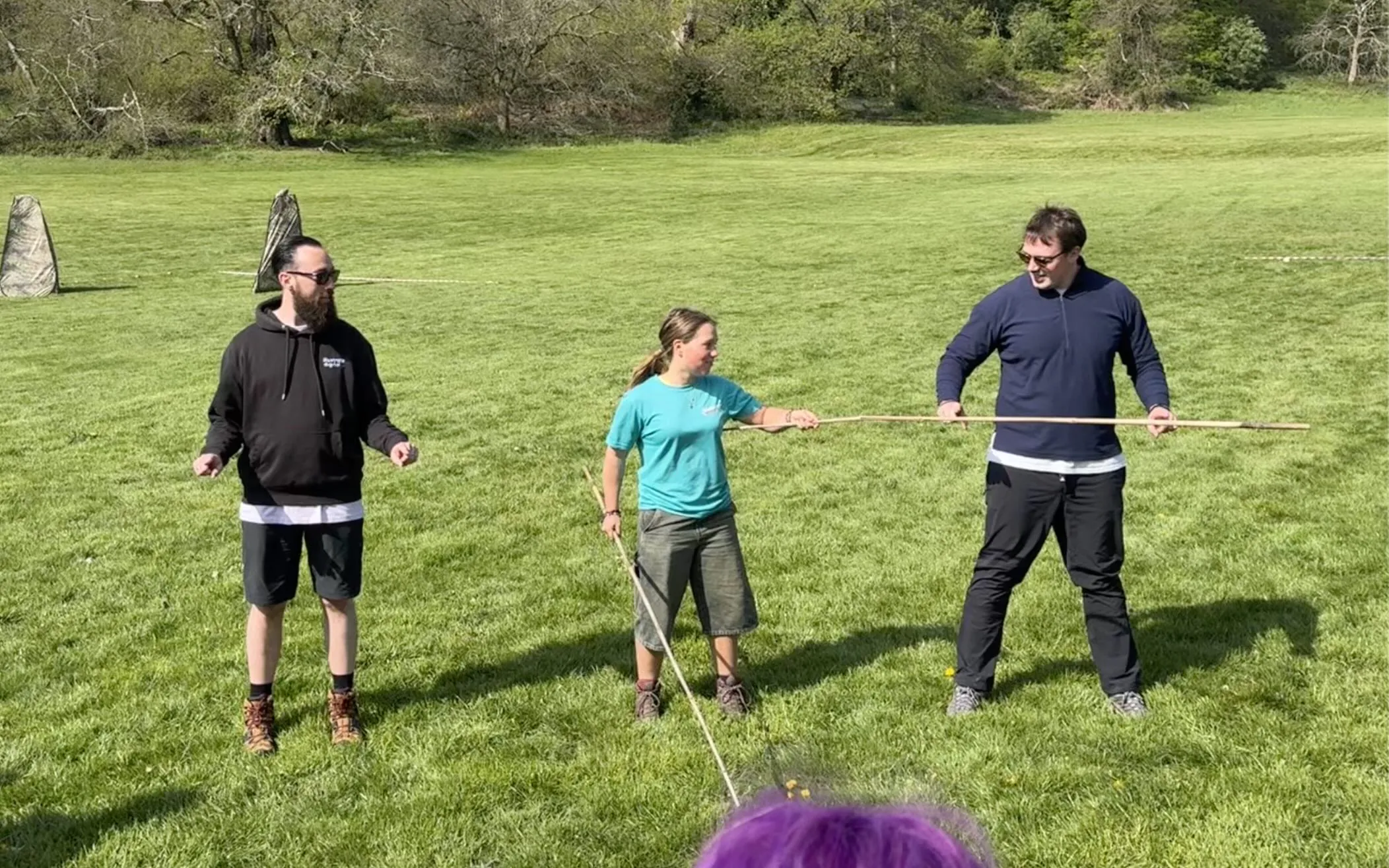 Scott Jones (CEO) and James Johnson (Delivery Director) of Illustrate Digital holding bamboo stick in team building exercise at Adventure Bristol