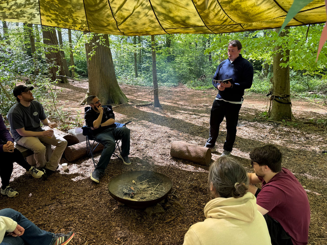 The Illustrate Digital team gathered around a campfire in Bristol